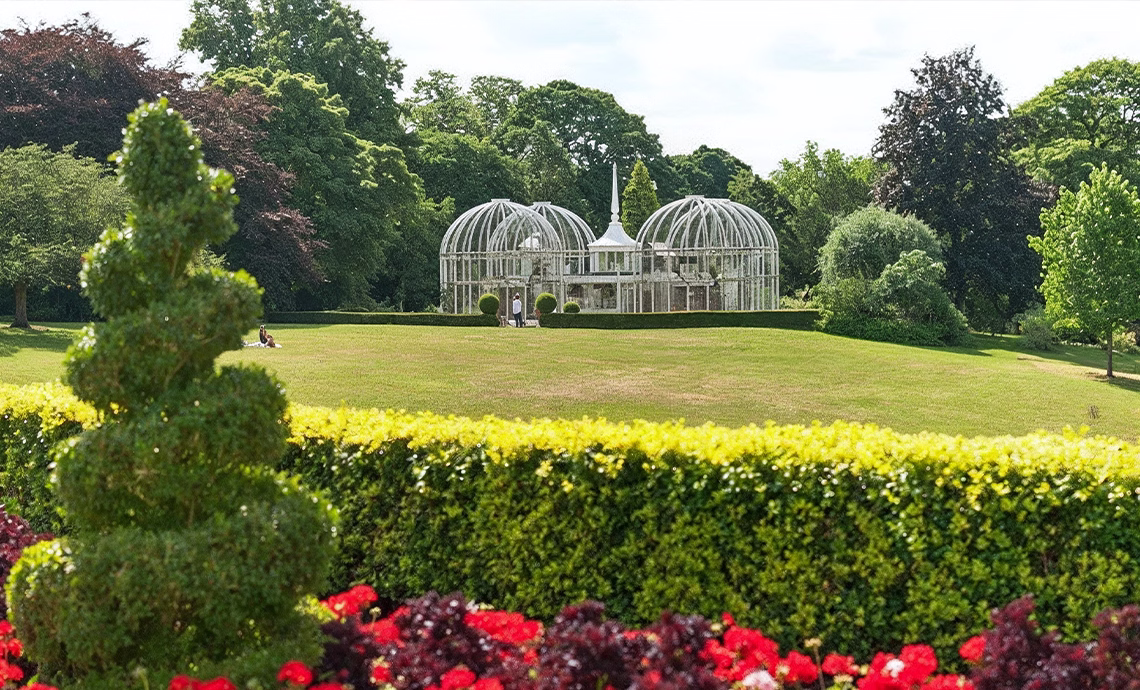 birmingham botanical gardens victorian glasshouse greenhouse with manicured hedges topiary colorful flower beds and lush lawns
