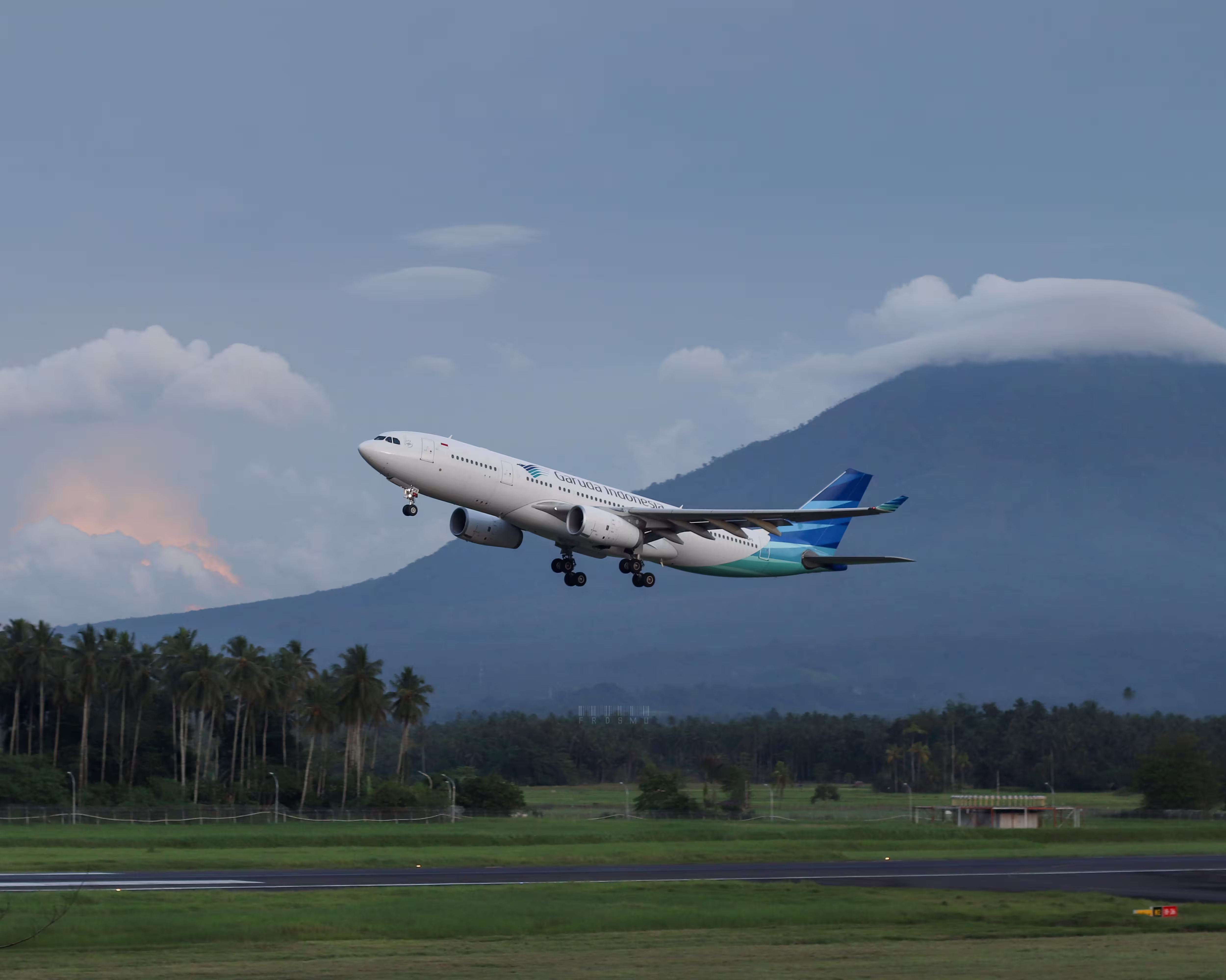 Airplane taking off at sunset