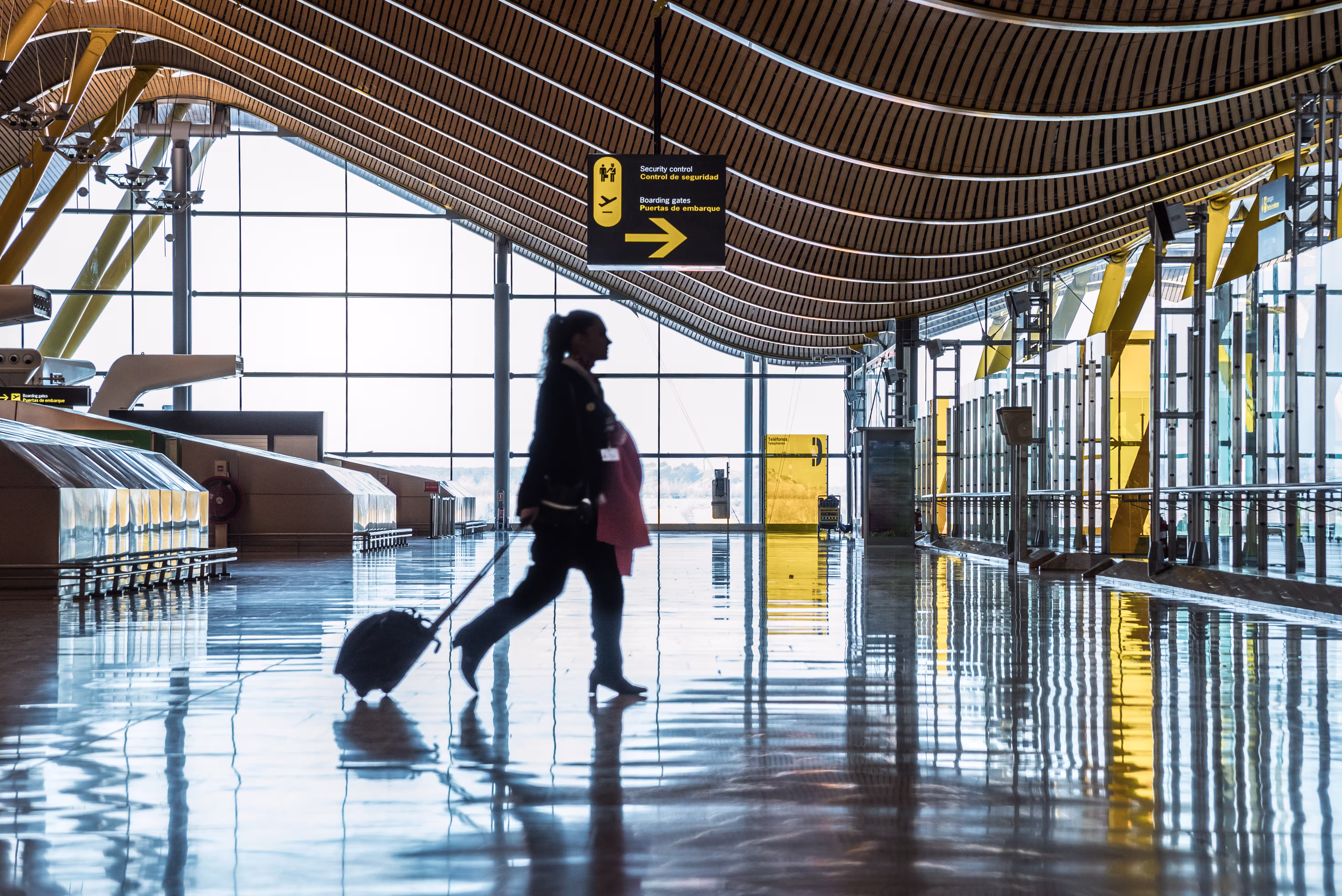 airport terminal with people moving silhouettes