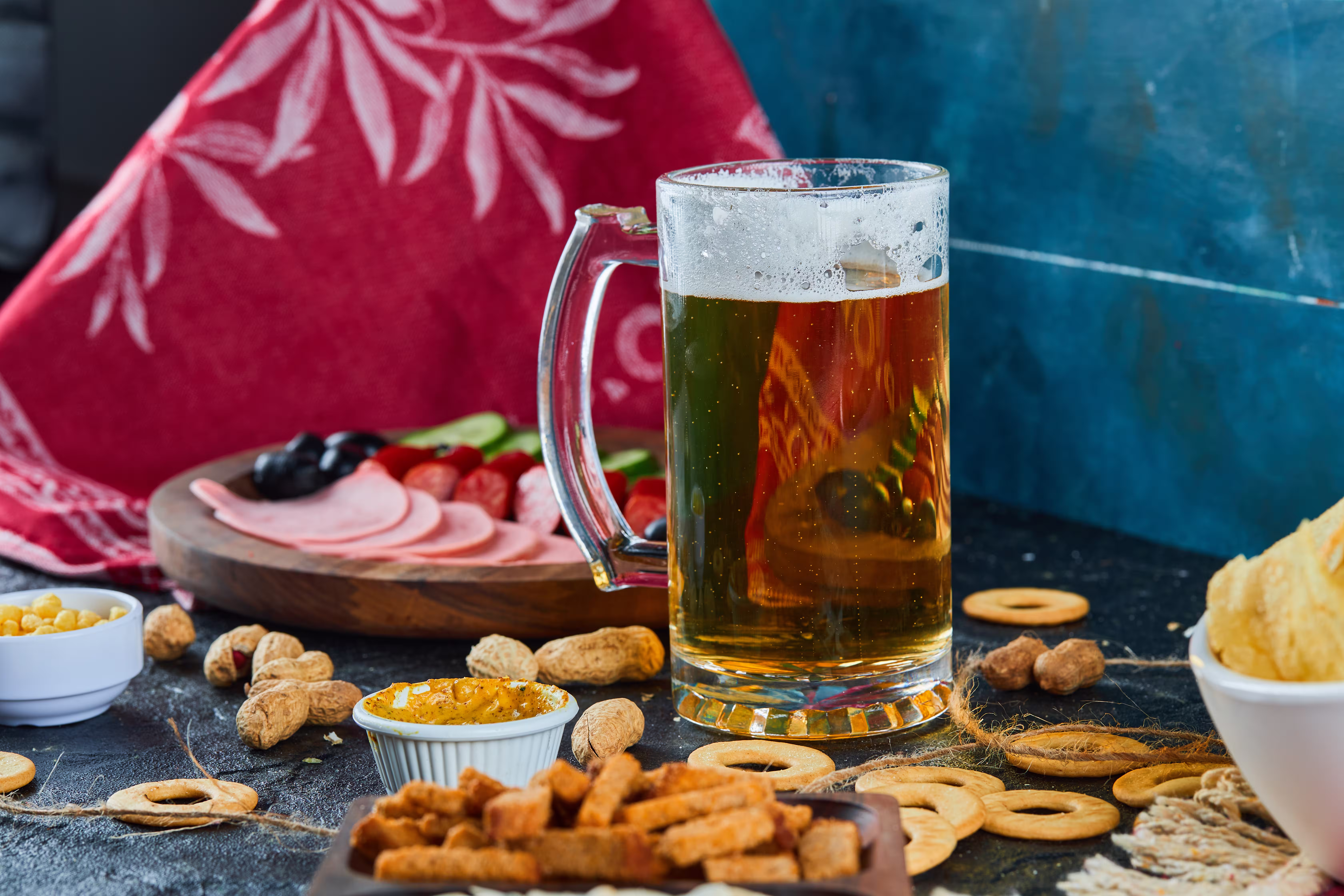 Assorted snacks, sausages, and a glass of beer