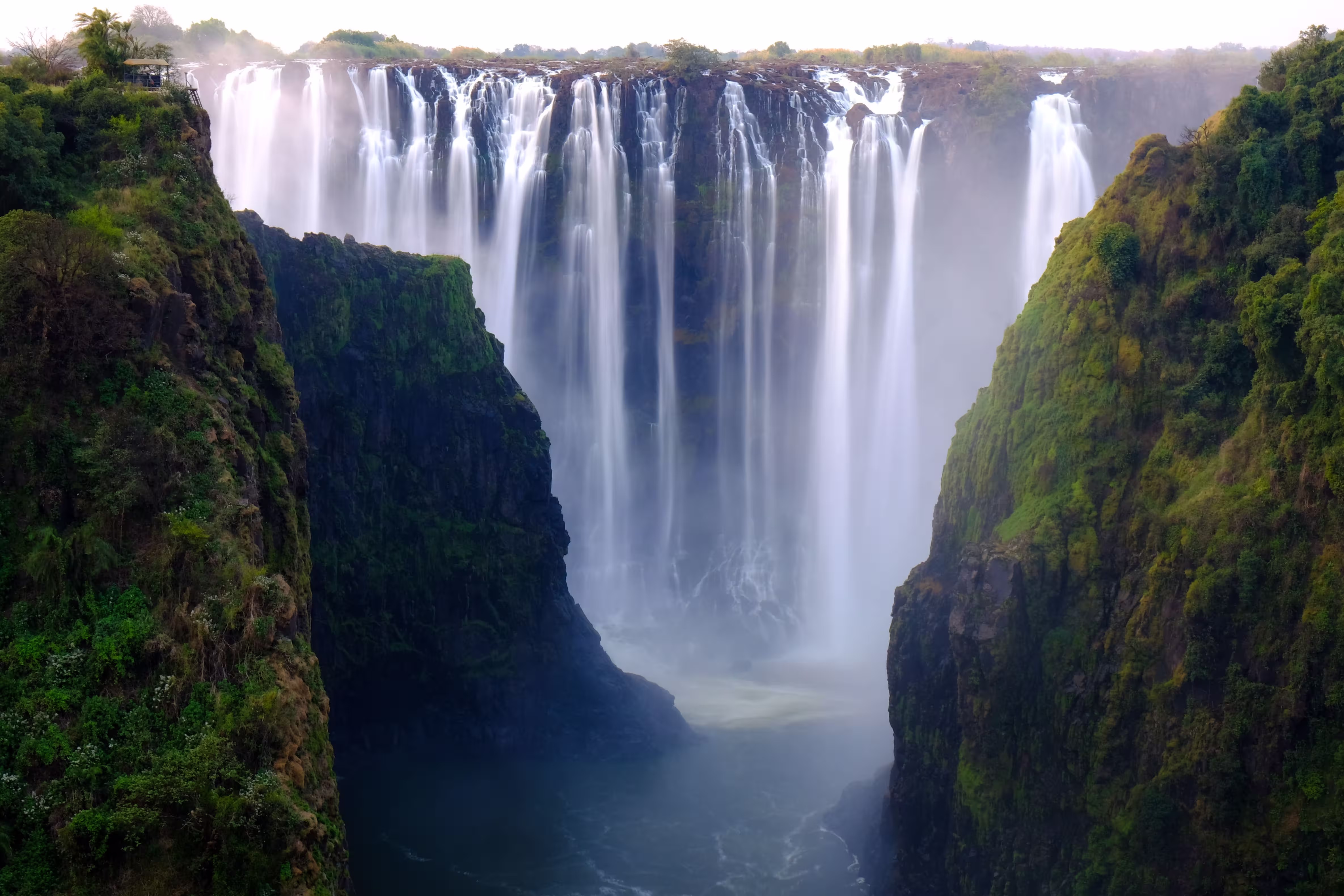 beautiful-shot-waterfall-surrounded-by-trees-hills