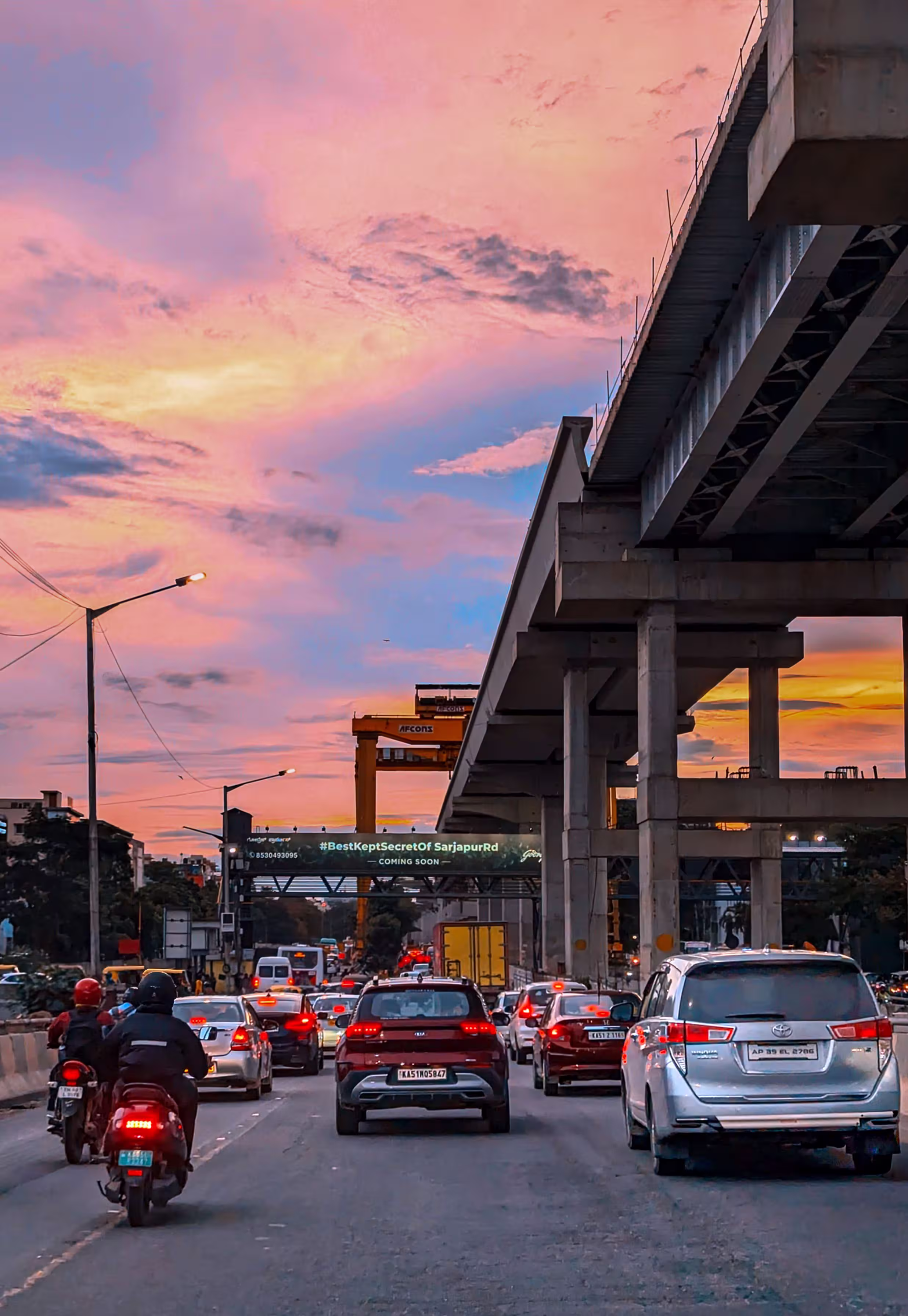 Bengaluru traffic under a vibrant sunset