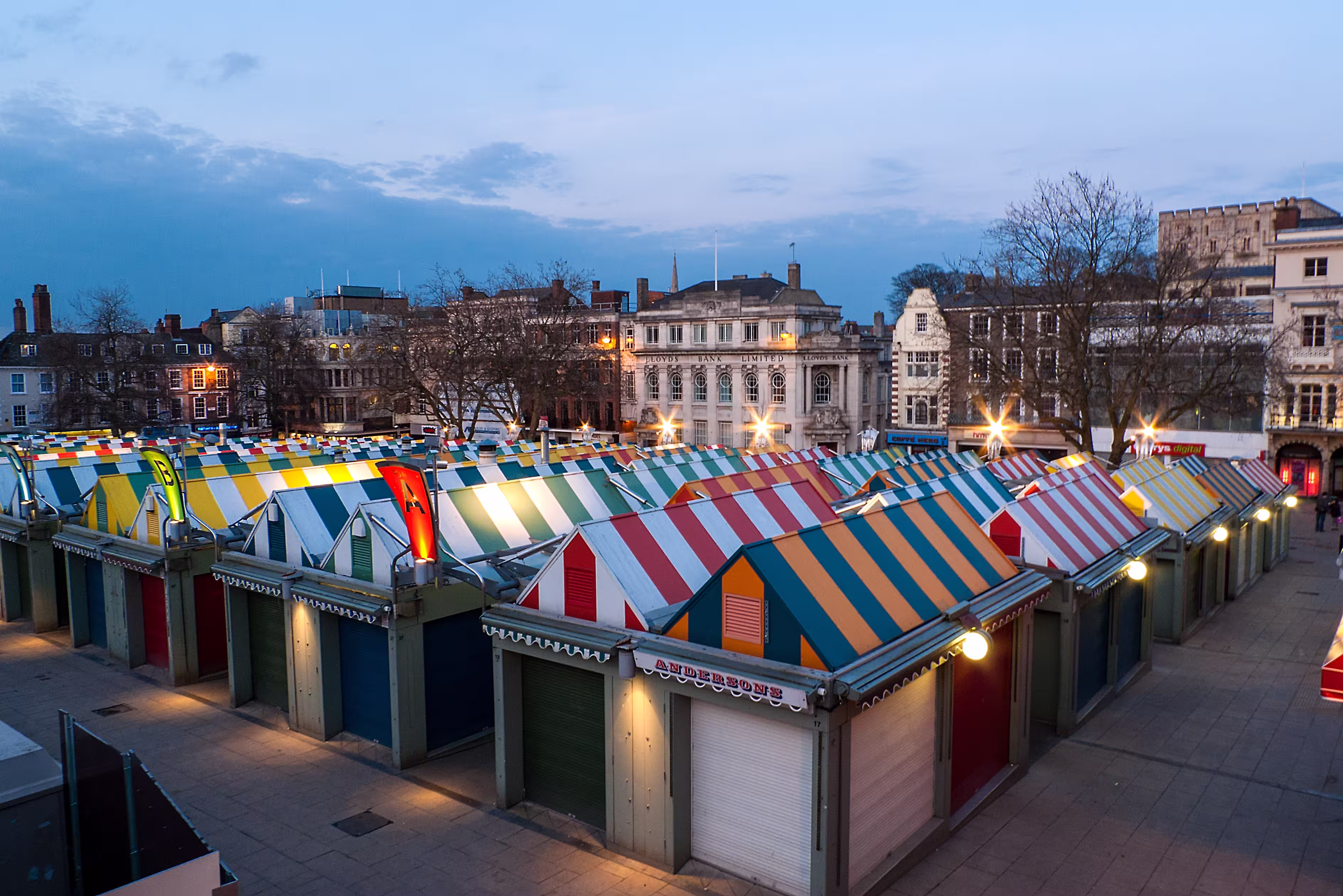 Colorful Norwich market and castle at dusk