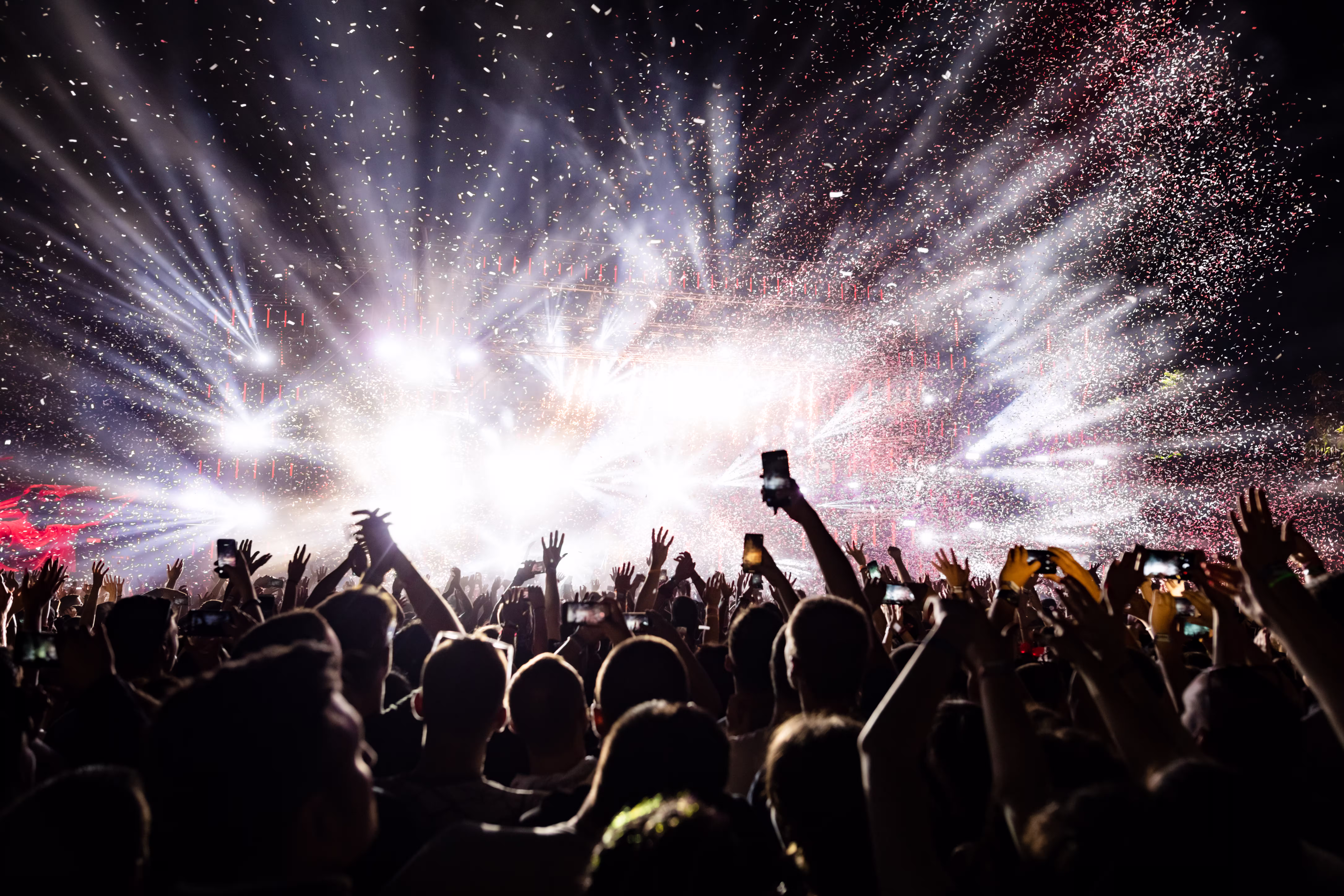 Excited audience watching confetti fireworks havin