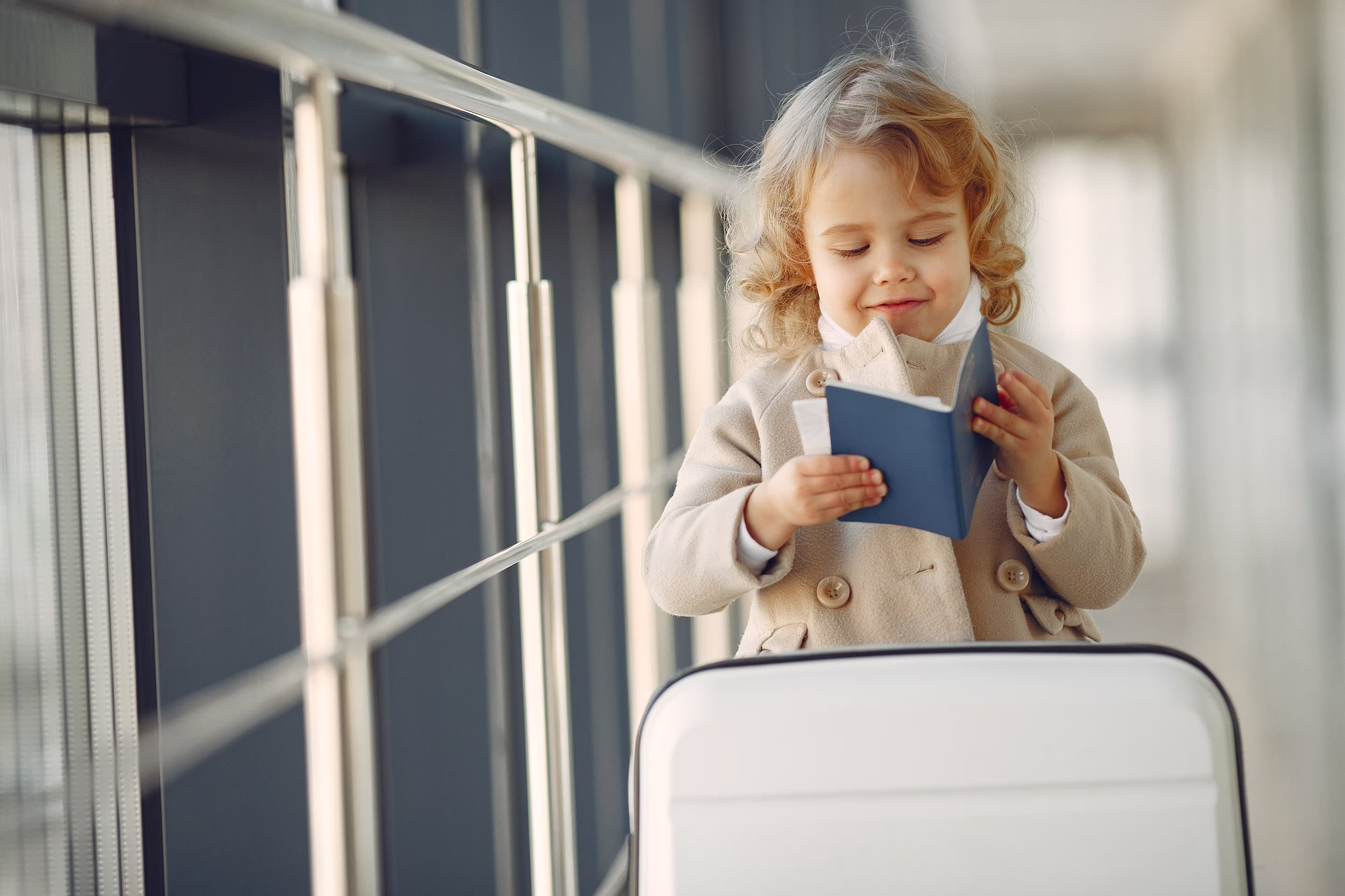 Little girl with a suitcase at the airport travelling internationally
