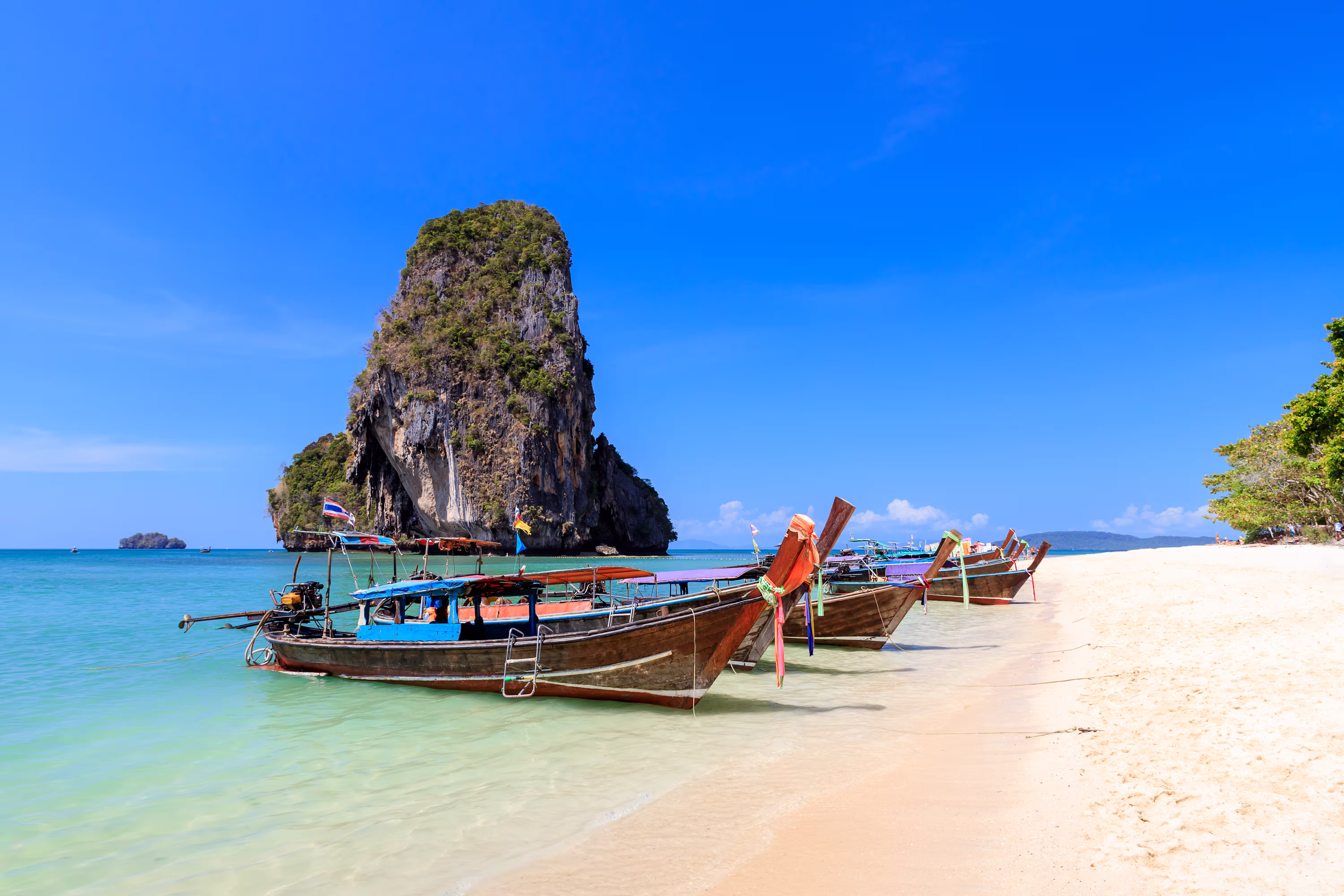 long tail boat turquoise crystal clear sea water