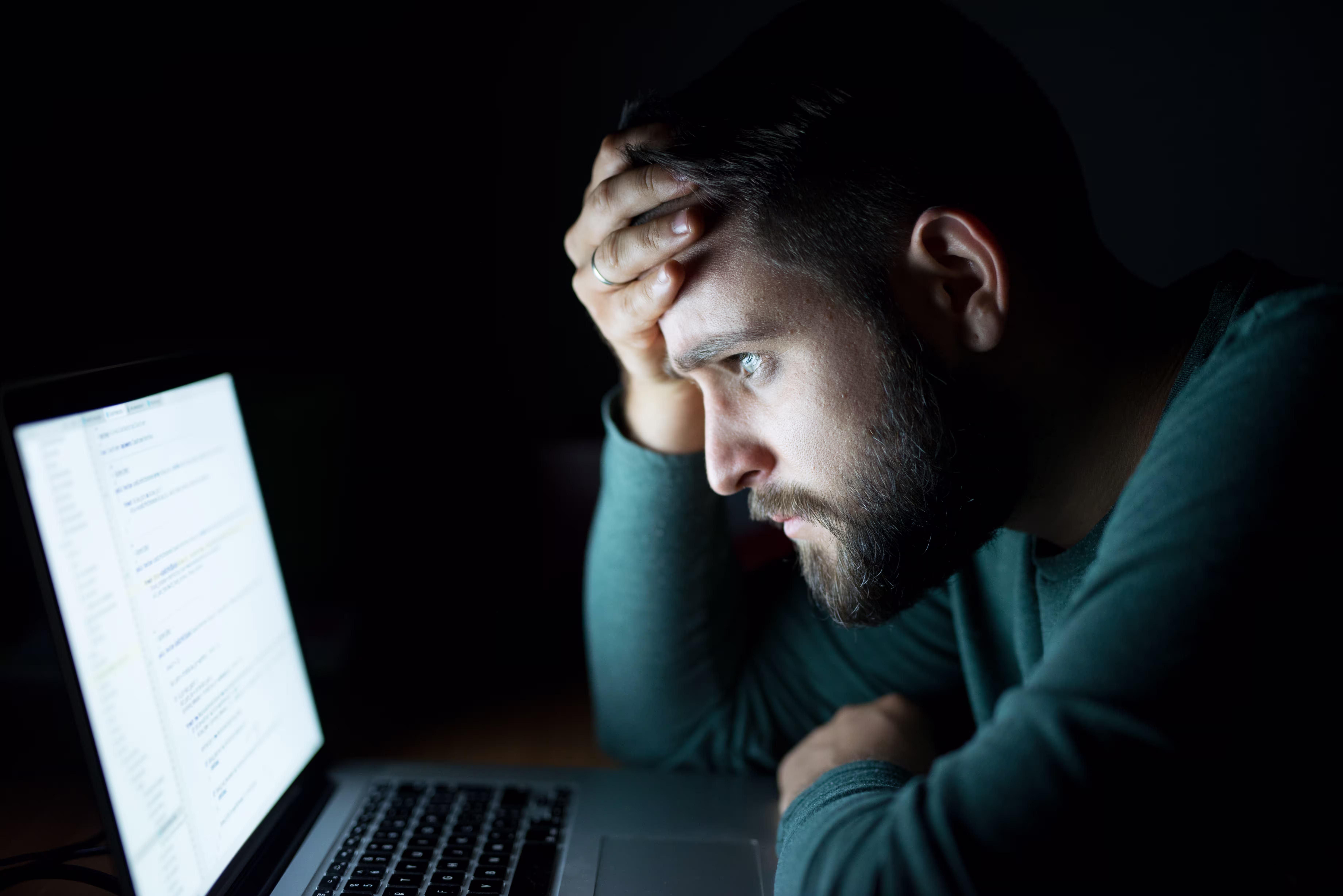 Man concentrating on his laptop while booking a mistake fare