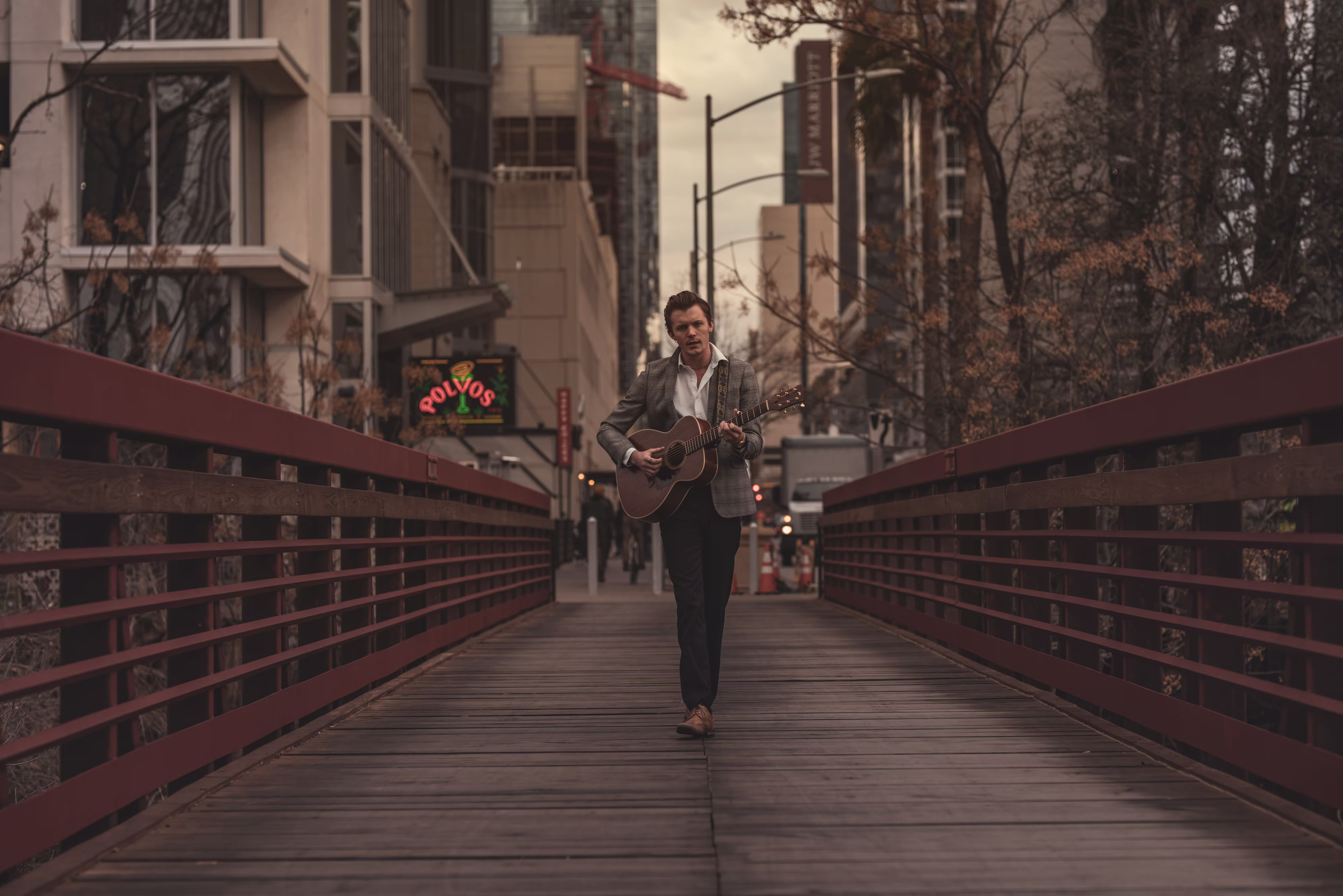 man-playing-guitar-in-footbridge