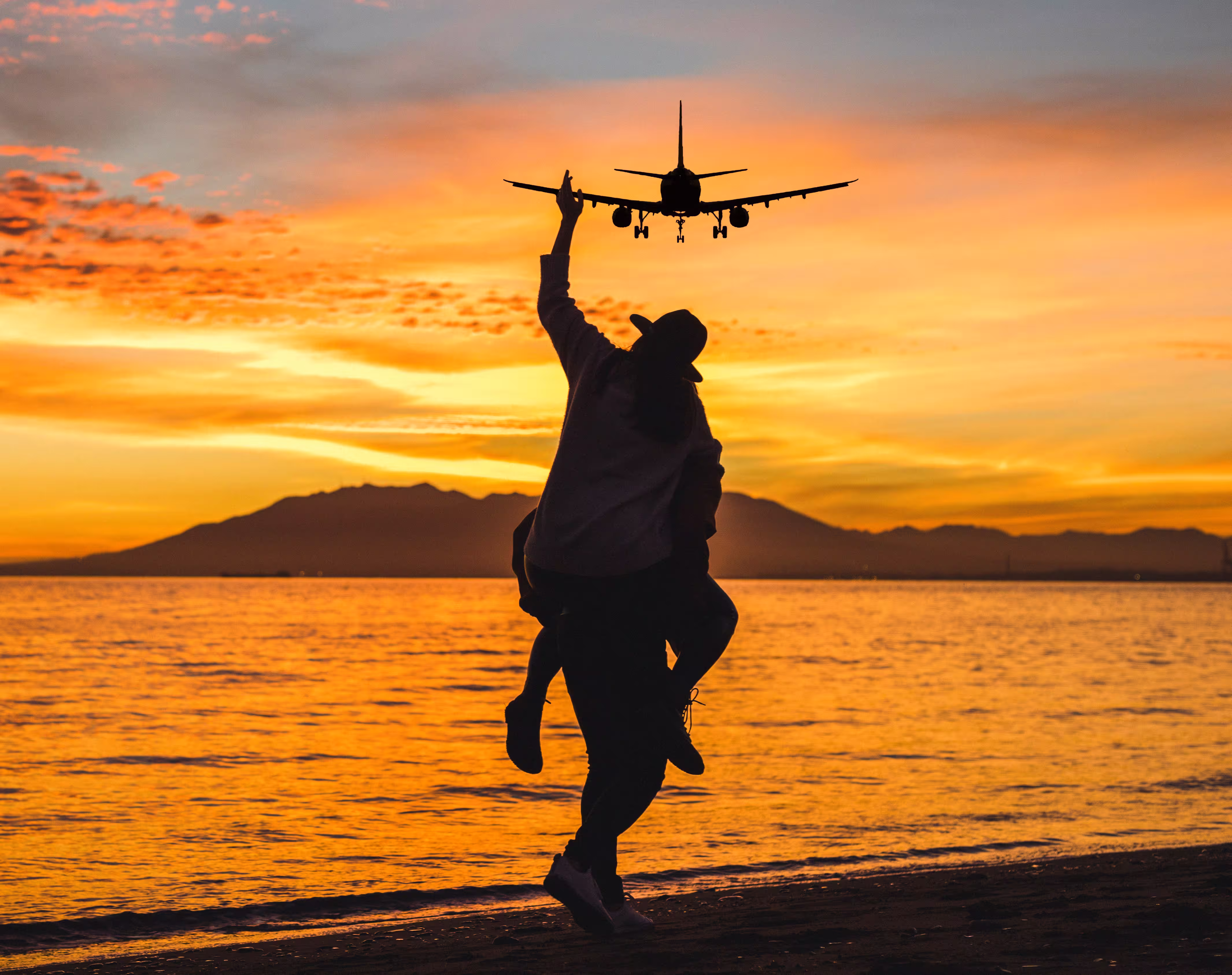 Airplane taking off at sunset