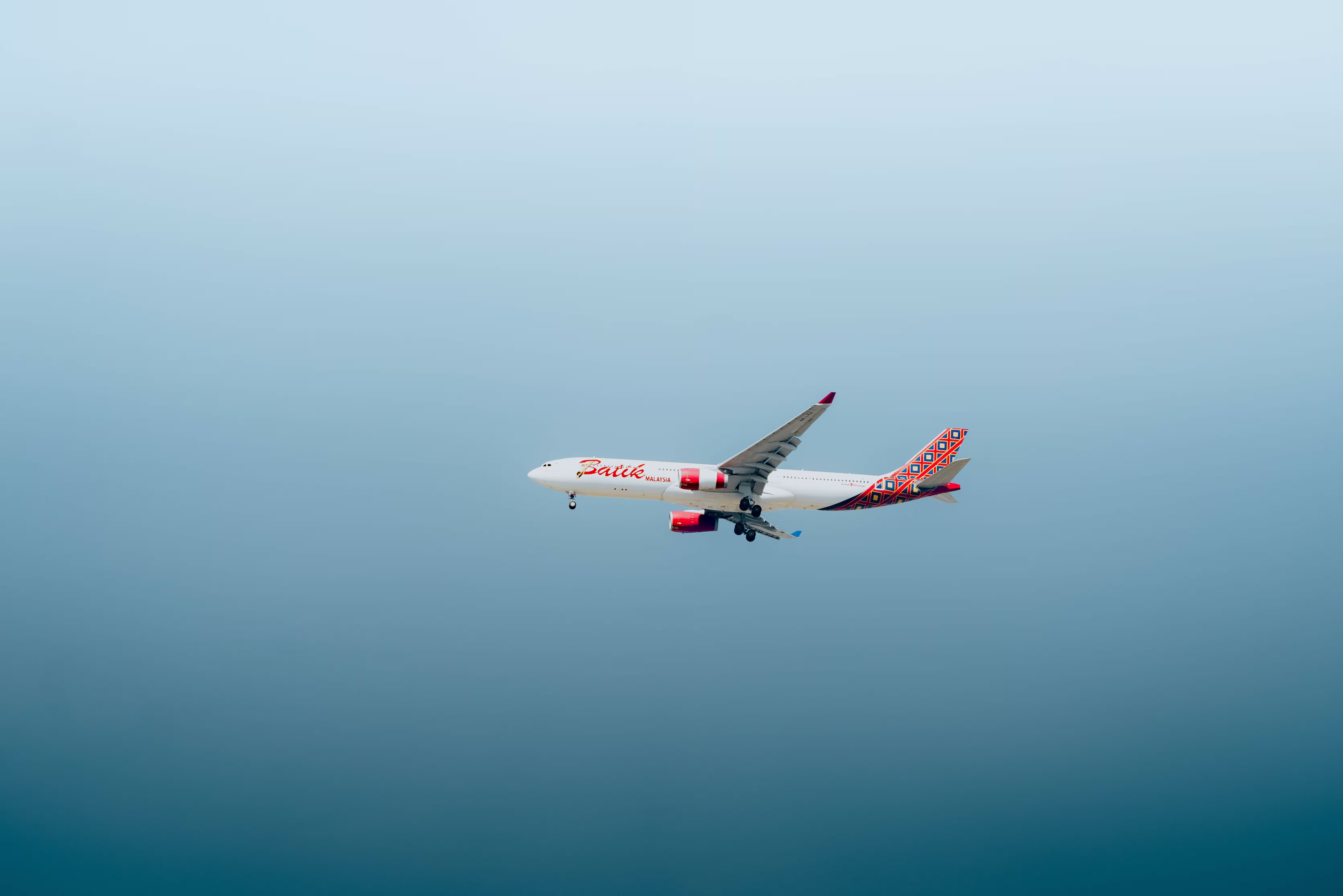 Airplane taking off at sunset