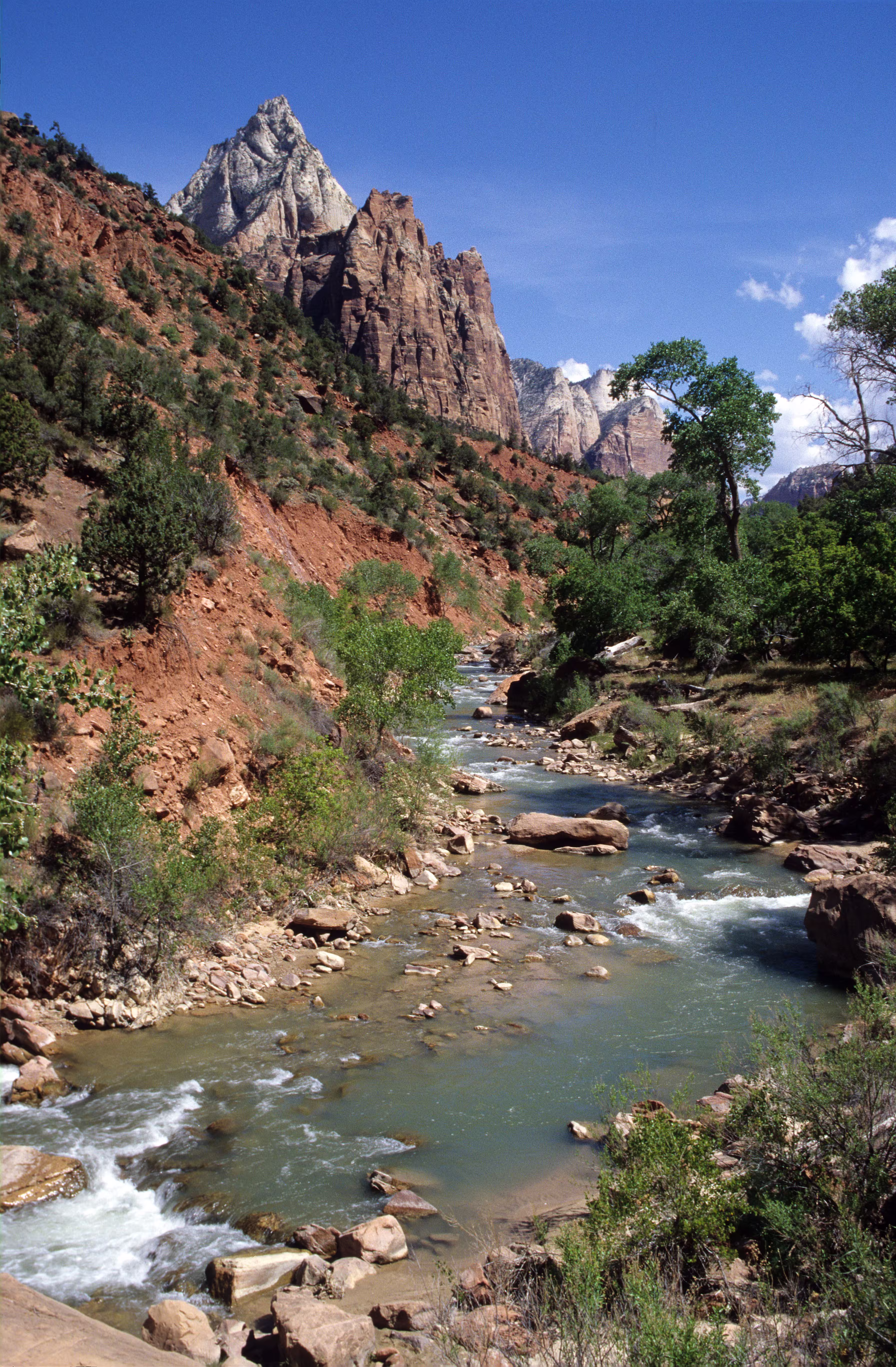 River near mountain under blue sky
