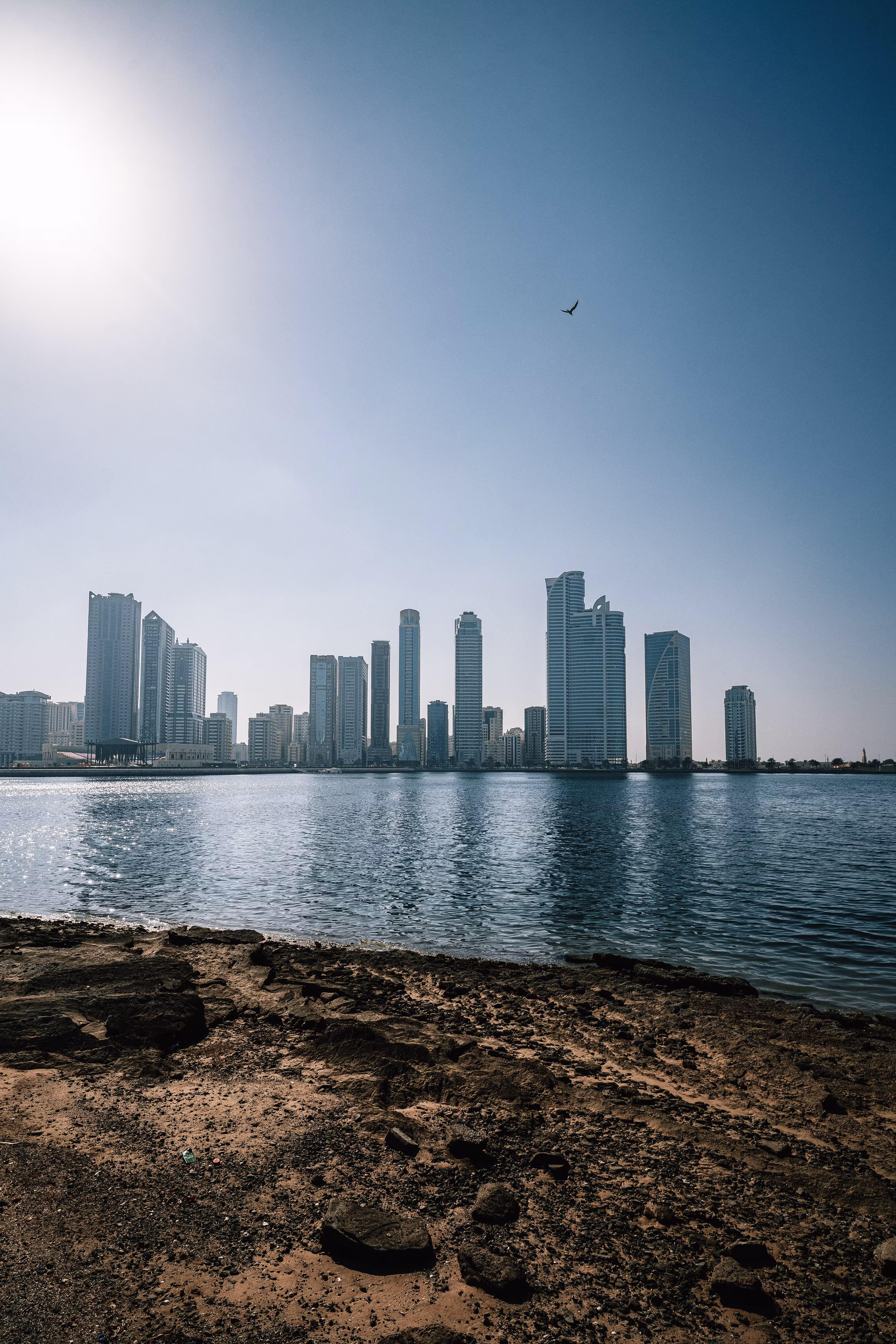 skyline of Sharjah with blue sky and water