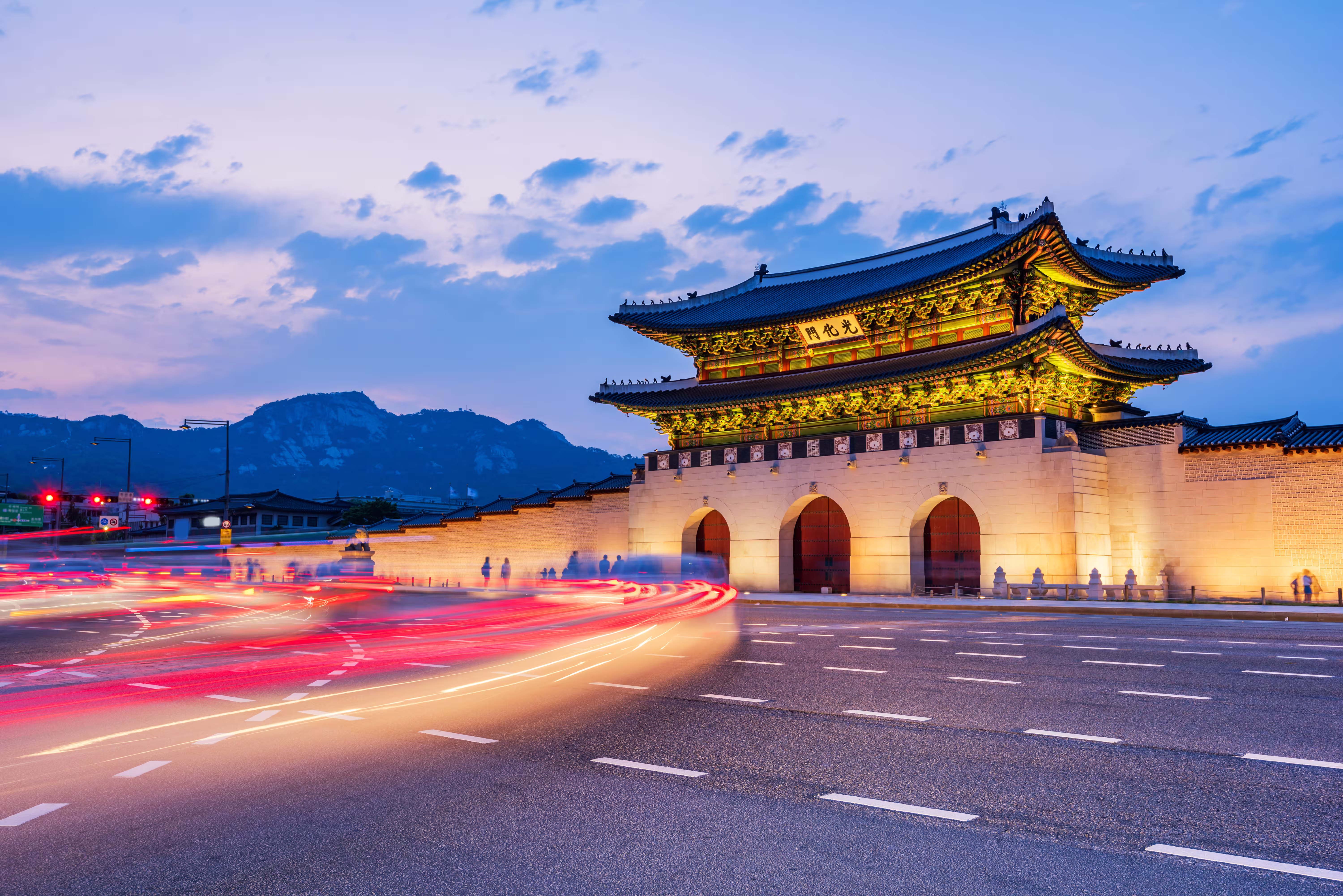 traffic blurs past gyeongbokgung palace night seoul