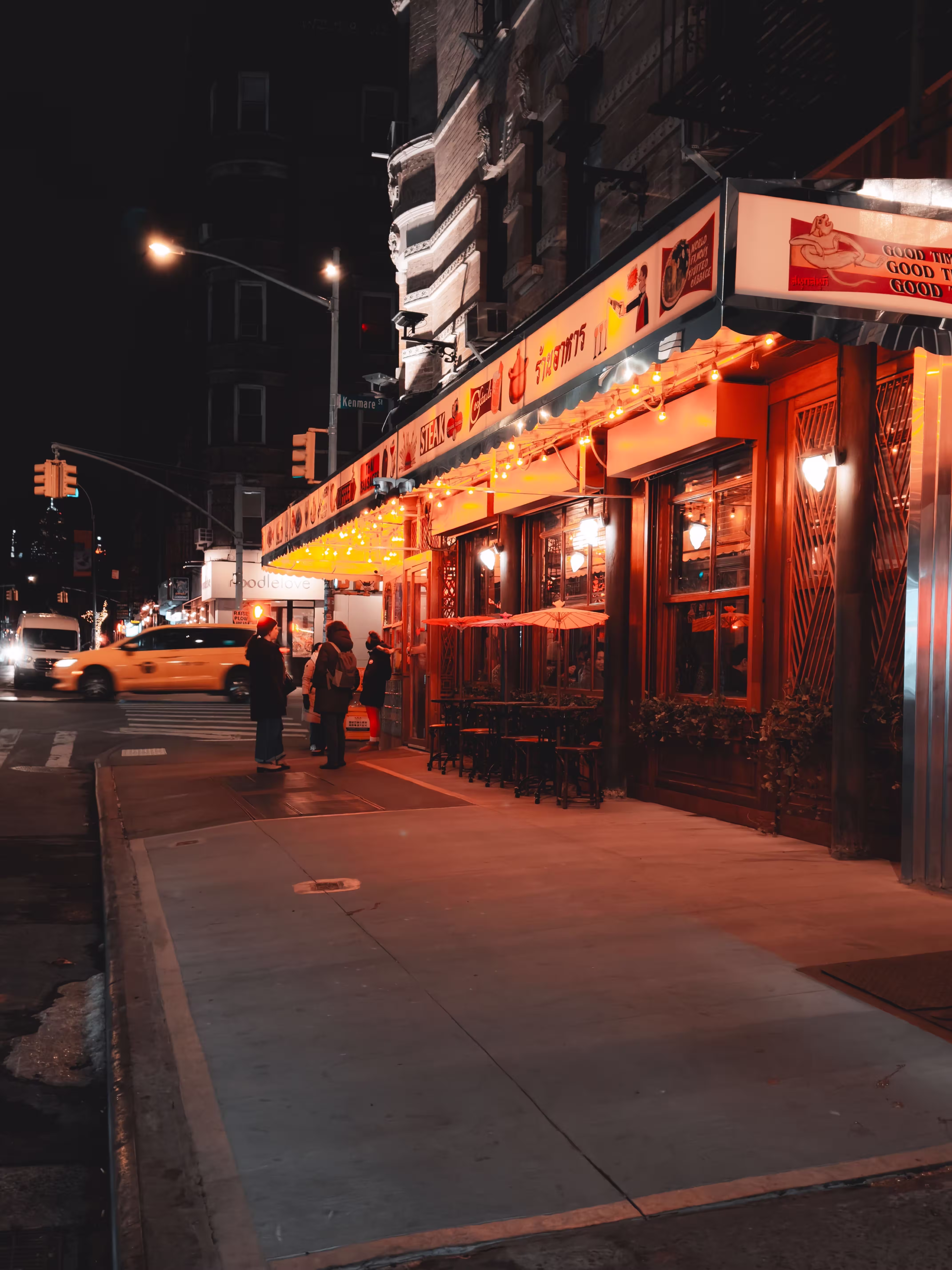 Vibrant NYC street scene with lit restaurant