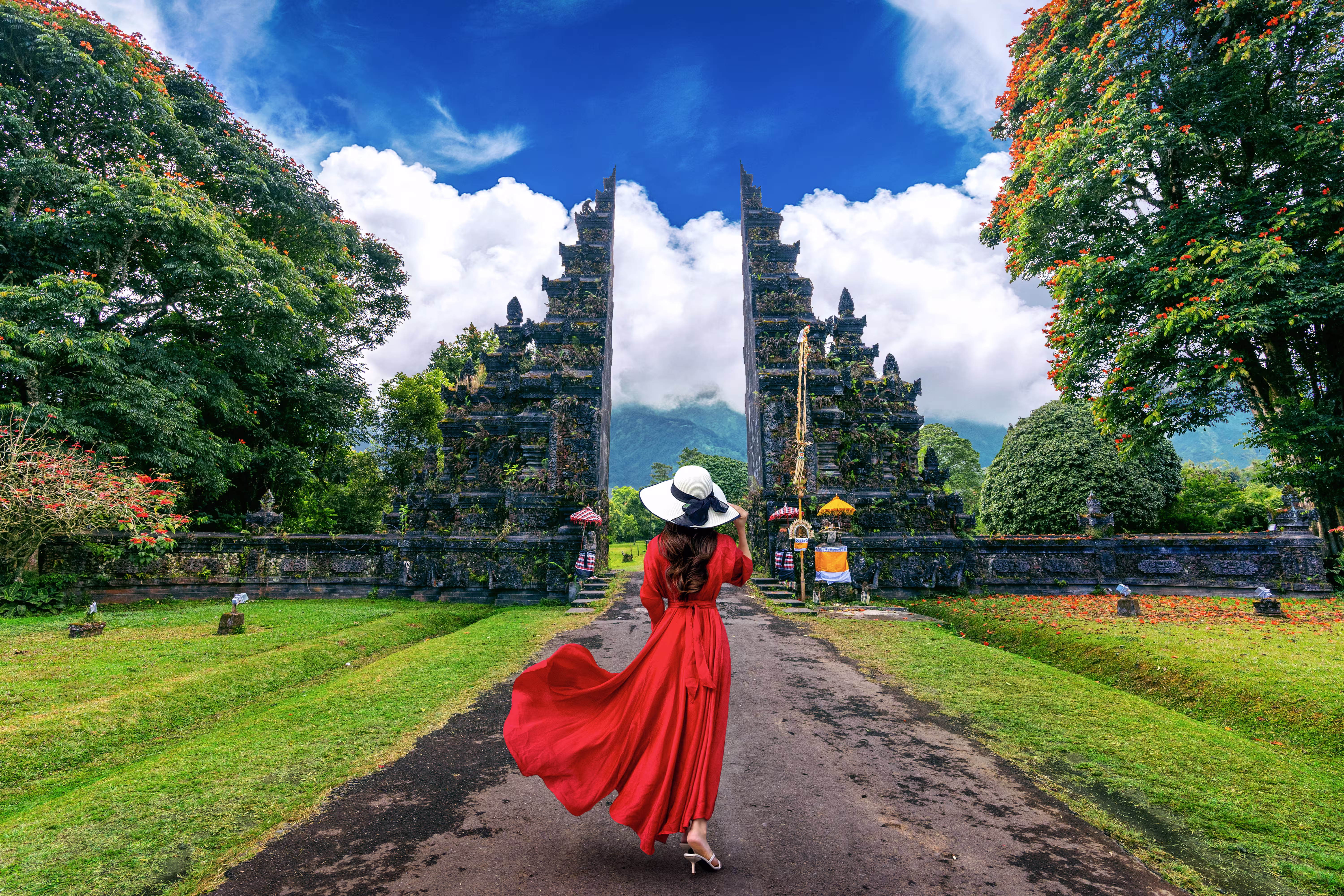 woman walking big entrance gate bali indonesia